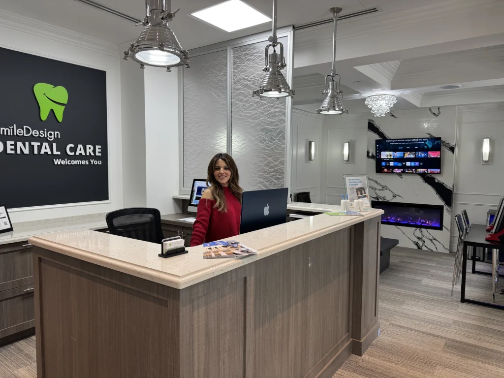 Reception desk and staff member at Smile Design Dental Care in Oakville